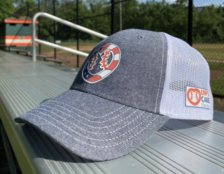 UMPS CARE Charities Stars and Stripes Logo Cap on Bleachers