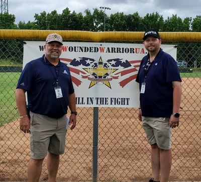 President with Brandon Lawson in Front of WWUA Banner