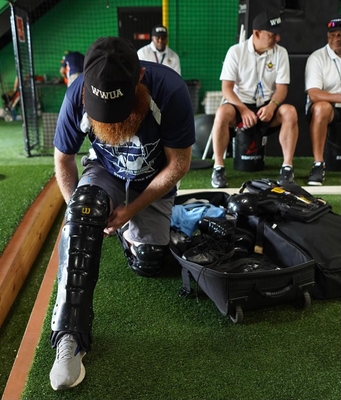 Student Putting on Umpire Shin Guards