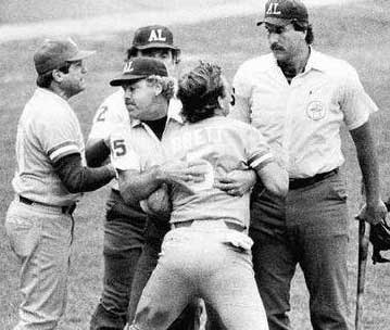 Joe Brinkman holds George Brett back